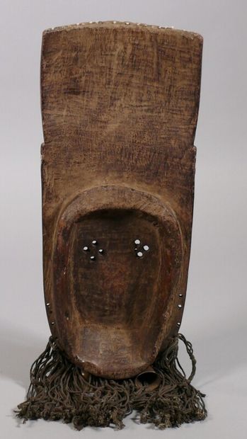 null Hardwood mask with a dark patina and white and blue polychromy, showing a flat...