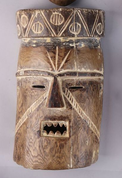 null Mask in medium-hard wood with traces of kaolin showing a face with a geometrical...