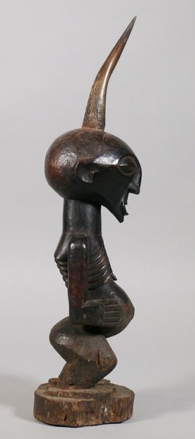 null Nkisi" fetish made of hard, heavy wood with a dark patina, depicting a standing...