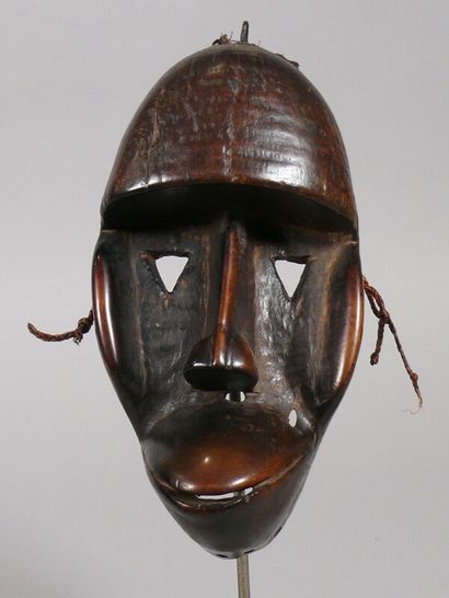 null Zooanthropomorphic mask made of hardwood with a dark glossy patina, showing...
