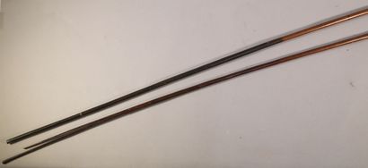 null Two hardwood spears with dark patina, one with blackened sections, with a thin...
