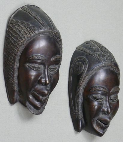 null Pair of bronze sconce masks with dark patina, cast with lost wax, depicting...