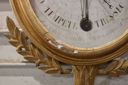 null Barometer, the gilded frame carved with laurels, the pediment decorated with...