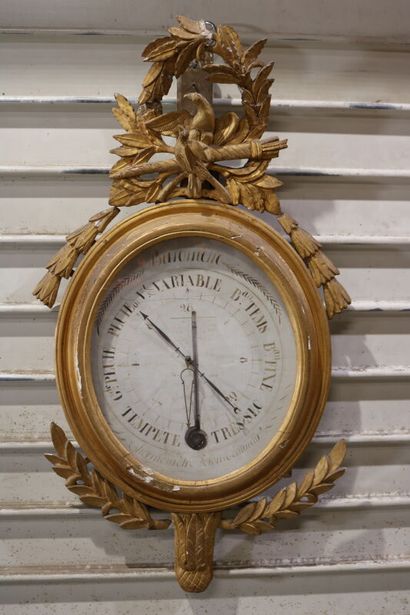 null Barometer, the gilded frame carved with laurels, the pediment decorated with...
