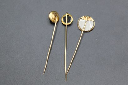 null Suite of three yellow gold tie pins, one decorated with a round porcelain plate...
