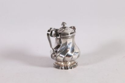 null Silver creamer resting on a heel, body with twisted ribs in recall on the lid....
