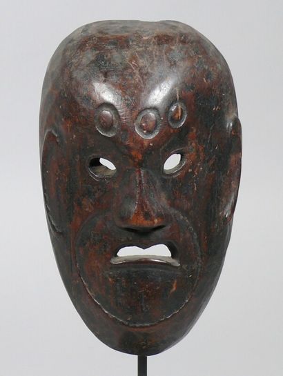 null Hardwood dance mask with a beautiful dark patina of use depicting a severe face...