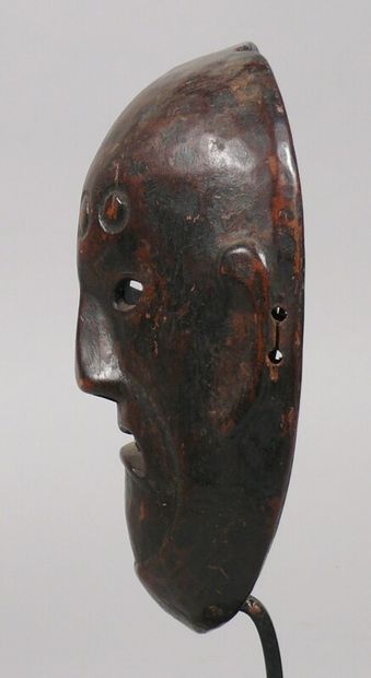 null Hardwood dance mask with a beautiful dark patina of use depicting a severe face...