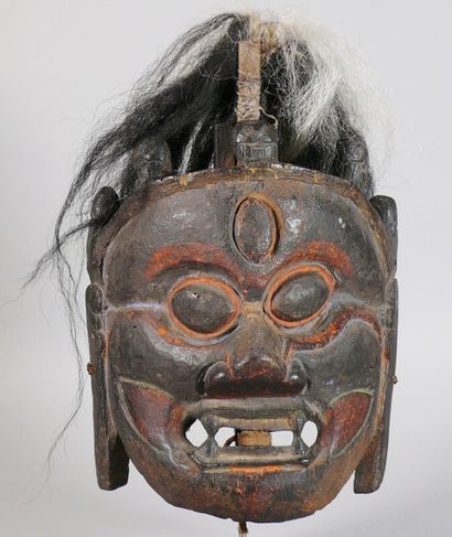 null Large hardwood mask of a deity with a thick black patina and red and blue pigment...