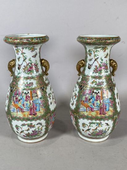 null CANTON 
A pair of porcelain baluster vases decorated in cartouches with palace...