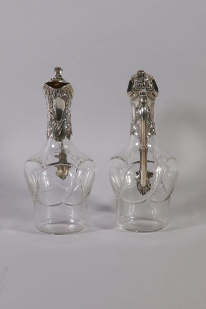 null Pair of ewers, in cut crystal and silver trim with rocaille decoration of cartouches...