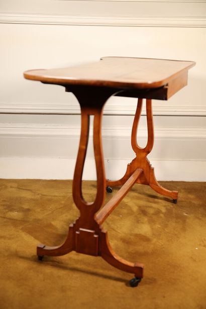 null Writing table in blond veneer wood opening with a drawer, lyre-shaped base on...