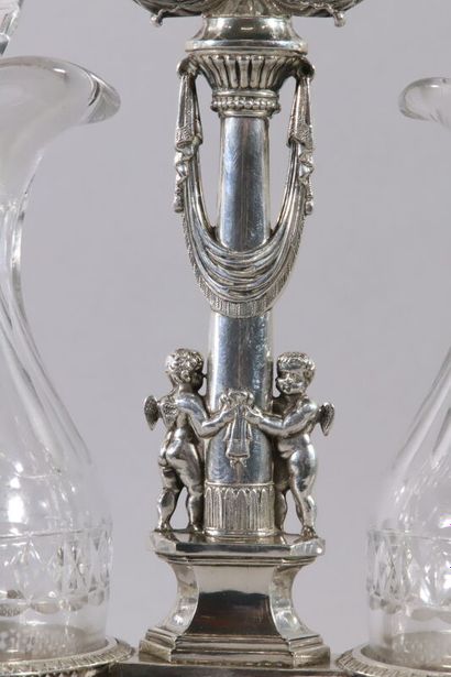null Rectangular silver oil cruet, the holders decorated with cherubs holding a torch...