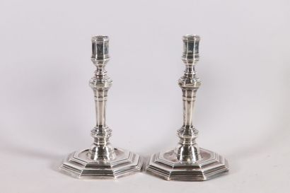 null Pair of silver candlesticks with sides resting on an octagonal base with steps...