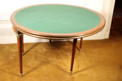 null Mahogany veneered dining and game table with three tops, resting on five tapered...