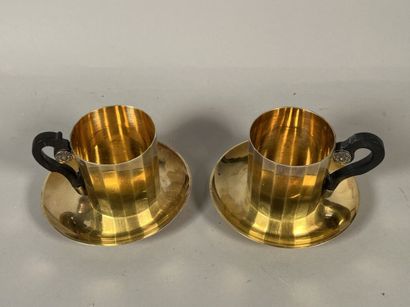 null Pair of cups and their saucers in vermeil with cut sides, the handles with blackened...