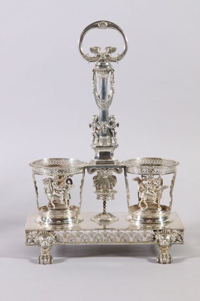null Rectangular silver oil cruet, the holders decorated with cherubs holding a torch...