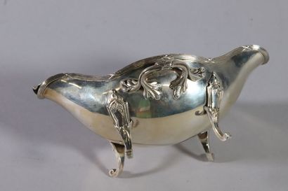null Silver sauceboat of shuttle form with two handles stylized with foliage, the...