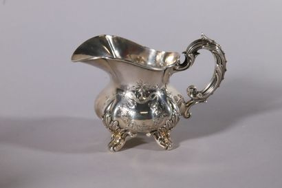 null Silver milk jug of baluster form with pinched ribs and engraved decoration of...