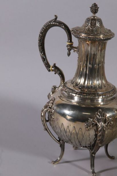 null Four-piece silver service of baluster form decorated with frets, laurels, water...