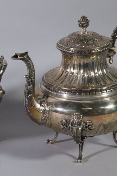 null Four-piece silver service of baluster form decorated with frets, laurels, water...