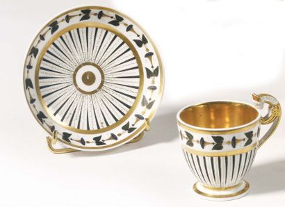 null Paris Pedestal cup and its porcelain saucer decorated in black and gold with...