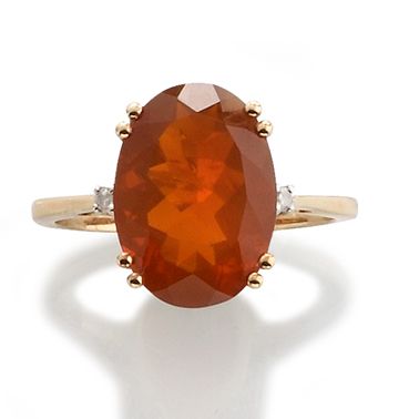 null RING 
 
in 375-thousandths yellow gold adorned with an oval-shaped fire opal...