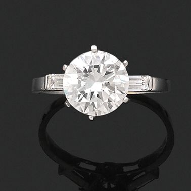 null SOLITAIRE RING 
 
in platinum with a modern brilliant cut diamond accompanied...