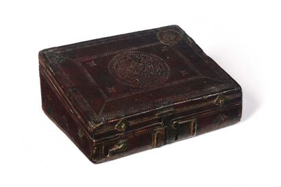 null A rectangular box set in embossed burgundy leather with small irons, it features...