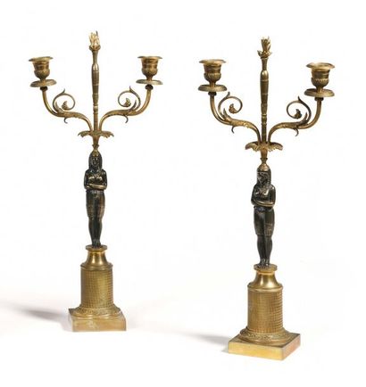 null PAIR OF CANDELABRATES in patinated and gilded bronze representing an Egyptian...