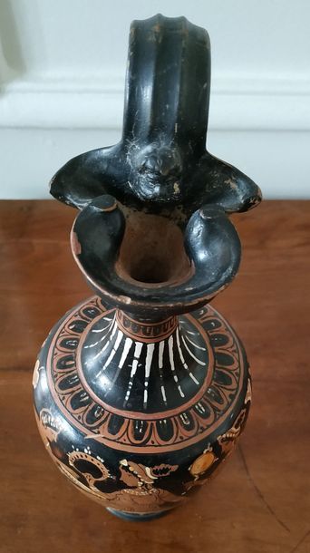 null OENOCHOE with pinched nose. Black glazed terracotta with red figures, creamy...