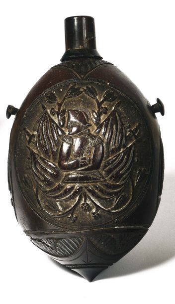 null Carved coconut flask, with two hanging buttons, decorated with three reserves:...