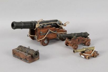 null THREE MARINE GUNSHOTS on their pedestals a howitzer is attached to them.