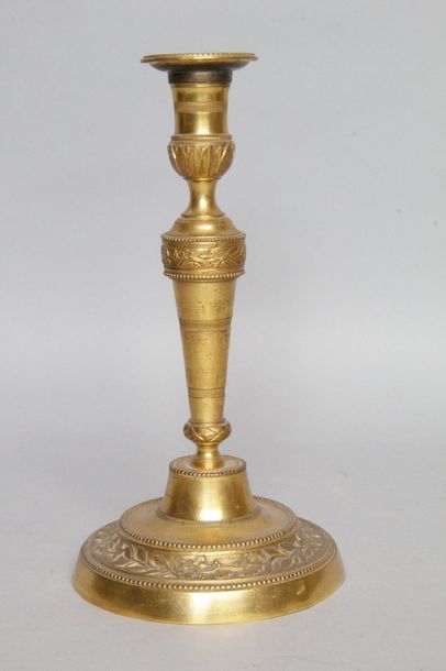 null Louis XVI style candlestick in gilt bronze with a baluster shaft, decorated...