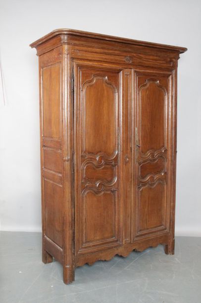 null Moulded and paneled oak CABINET. It opens with two rounded leaves and rests...