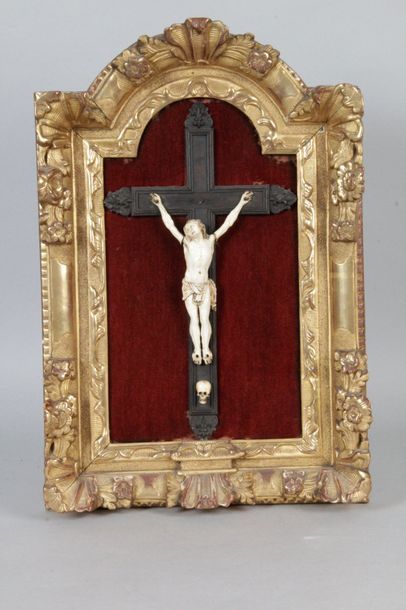 null TABLES CRUCIFIX Christ in ivory on a blackened wooden cross on a red velvet...