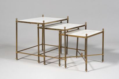 null IN THE TASTE OF THE HOUSE BAGUES Suite of three nested tables, gilded brass...