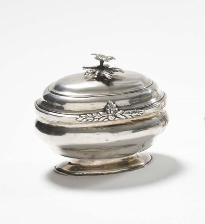 null Oval sugar bowl in plain silver, resting on a pedestal, the lid hinged, the...