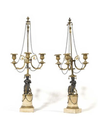 null Pair of gilded and patinated bronze child-blower candelabra with three arms...