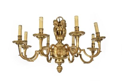 null Eight-branched gilt bronze chandelier decorated with foliage scrolls, surmounted...