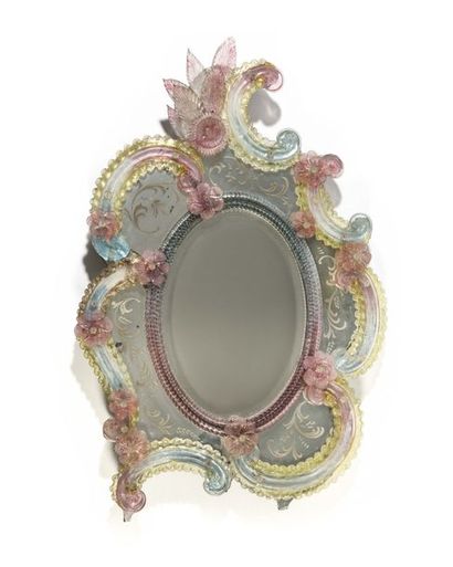 null Asymmetrical Venetian glass mirror, decorated with blue and pink tinted flowers...