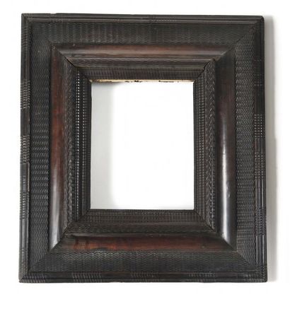null Venetian frame in stained wood, decorated with canals and wavy decoration, the...