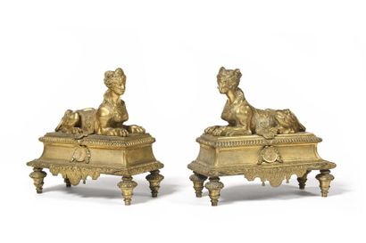 null Pair of ormolu sphinxes andirons, resting on a base decorated with profiles,...