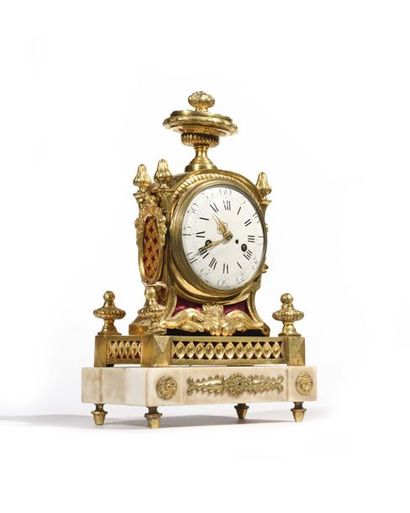 null Gilt bronze and white marble clock, the dial with Roman and Arabic numerals...