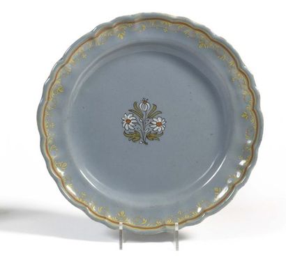 null Italy Plate with contoured rim in earthenware on a bluish grey background with...