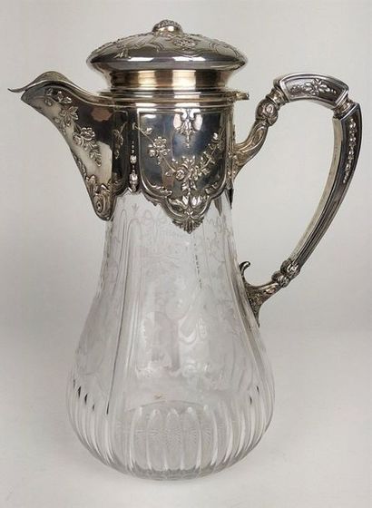 null Engraved crystal water jug, the frame in chased silver with a garland of flowers....