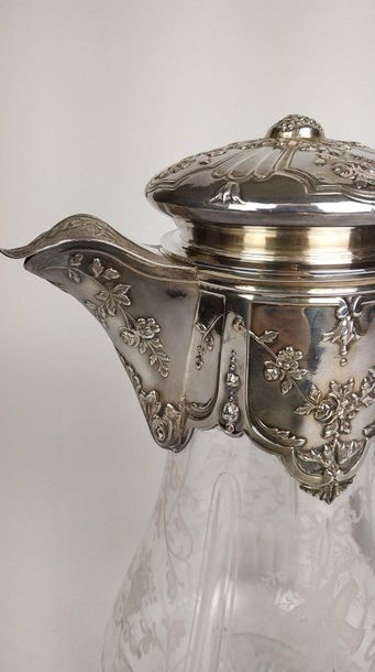 null Engraved crystal water jug, the frame in chased silver with a garland of flowers....