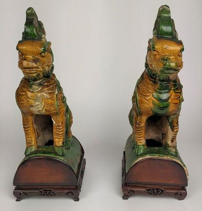 null CHINA Pair of glazed earthenware ridge tiles decorated with dogs of Fô. Wooden...
