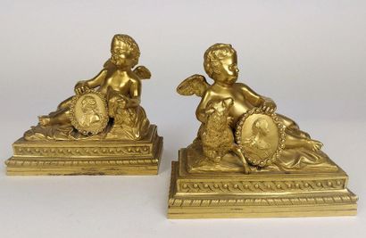 null PAIR OF GROUPS in chiselled gilt bronze with a decoration of reclining cherubs...