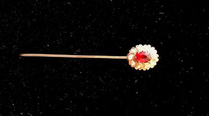 null PINK PINK in yellow gold decorated with a ruby surrounded by half fine pearls....